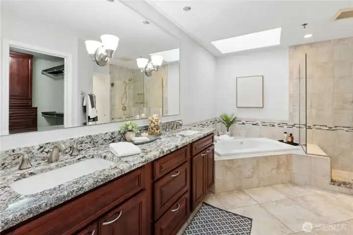This luxurious, updated 5-piece bath has a skylight, heated floors, a heated towel bar and a bubble massage tub. This luxurious, updated 5-piece bath has a skylight, heated floors, a heated towel bar and a bubble massage tub.
