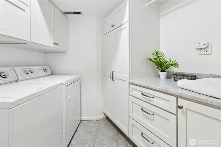 Lower level laundry room with tile floors, Speed Queen washer and dryer, plenty of cabinets and hanging space. Lower level laundry room with tile floors, Speed Queen washer and dryer, plenty of cabinets and hanging space.