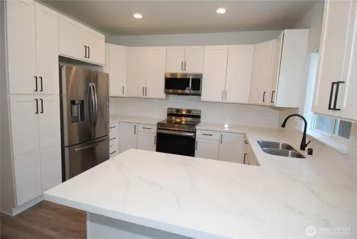 Full gourmet kitchen with quartz counter tops and Stainless steel appliances