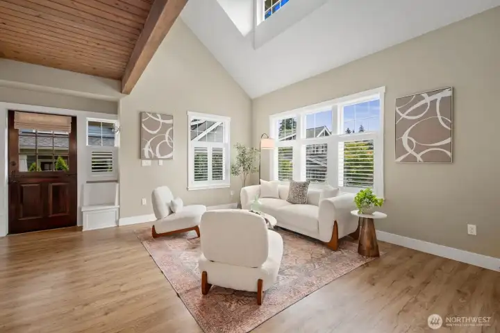 Open concept living room beautiful haed wood floors and wood beam ceilings with so much natural light.