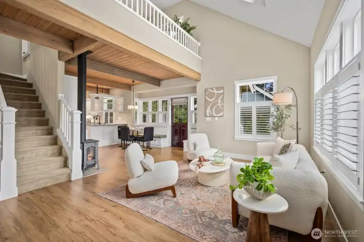 Open concept living room beautiful haed wood floors and wood beam ceilings with so much natural light.