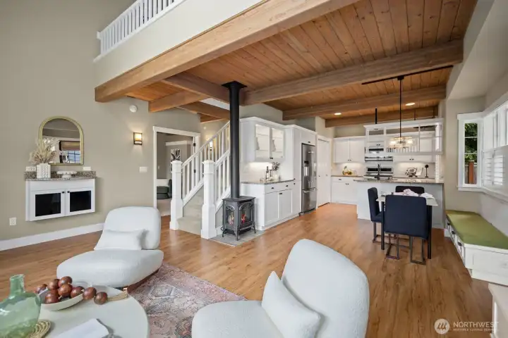 Open concept living room beautiful haed wood floors and wood beam ceilings with so much natural light.