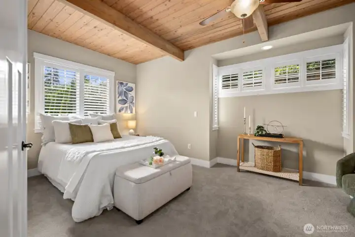 Light filled luxury main level primary suite with large walk in closet and additional seating area.
