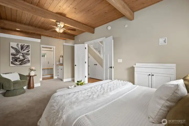 Light filled luxury main level primary suite with large walk in closet and additional seating area.