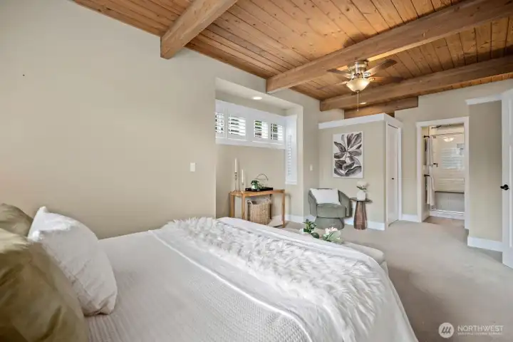 Light filled luxury main level primary suite with large walk in closet and additional seating area.