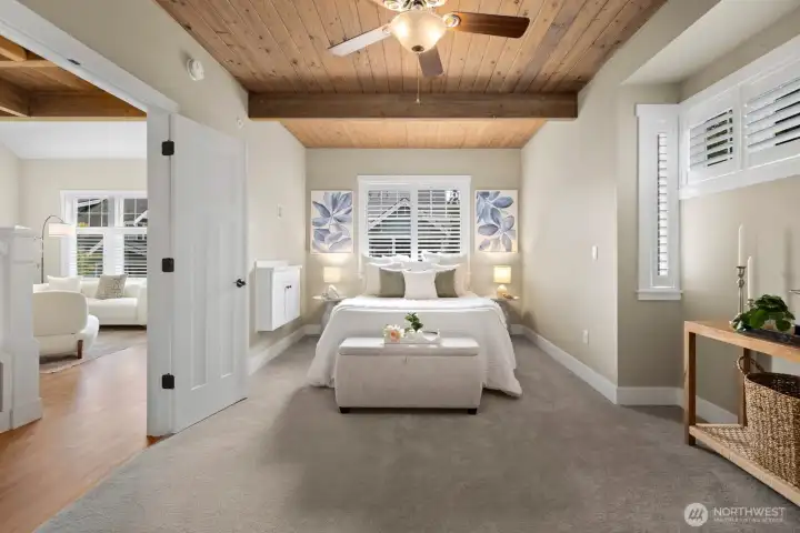 Light filled luxury main level primary suite with large walk in closet and additional seating area.