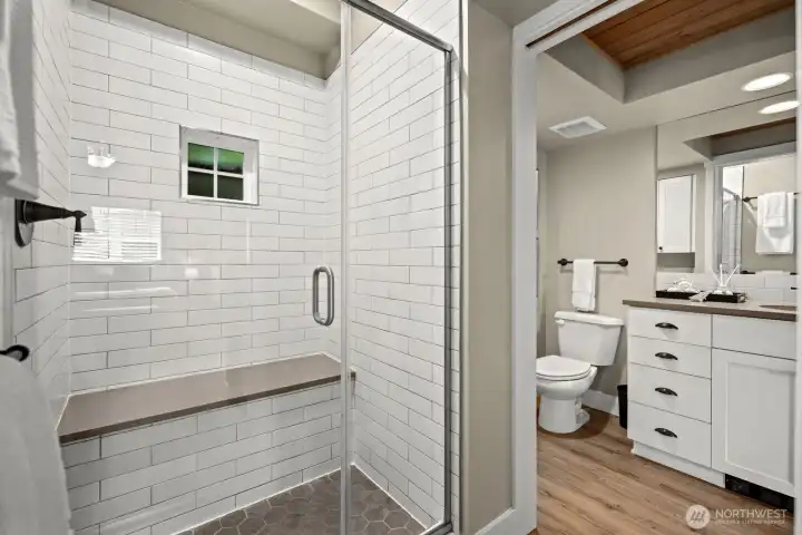 Bathroom off the primary with a seated shower bench
