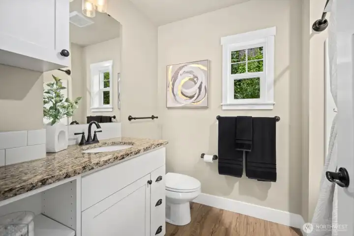 Second bathroom with soaking tub and extra storage.