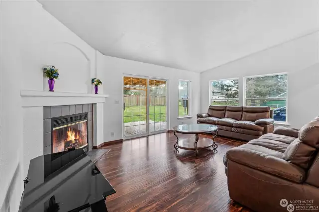 2nd Living room area with fireplace and sliding door leading to back yard and porch area