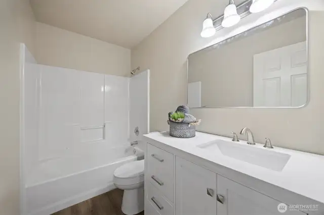 Guest Bath, new lighting, new mirrors, new flooring, new toilet.
