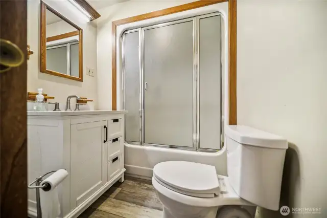 Full bathroom combined with a convenient laundry area.
