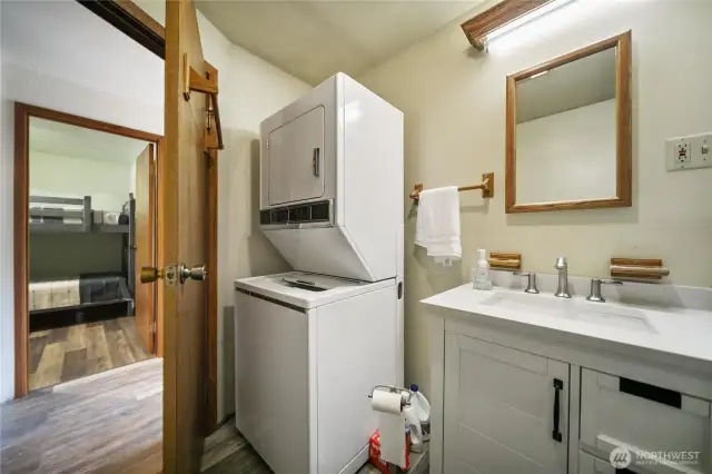 Another angle of the bathroom, showing the integrated laundry space.