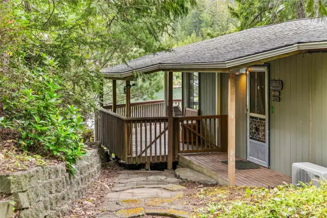 The main entrance welcomes you to the cabin, complemented by a wraparound covered deck.