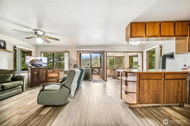 The open-concept living area is filled with natural light and offers stunning views of the lake through numerous windows.