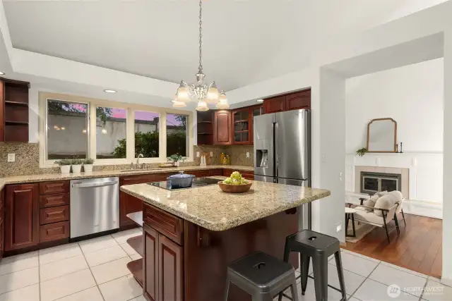 Kitchen features stainless steel appliances  recessed lighting, and a eat-in island with ample storage.