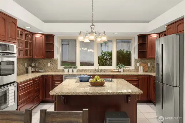 Kitchen features stainless steel appliances  and a eat-in island with storage.