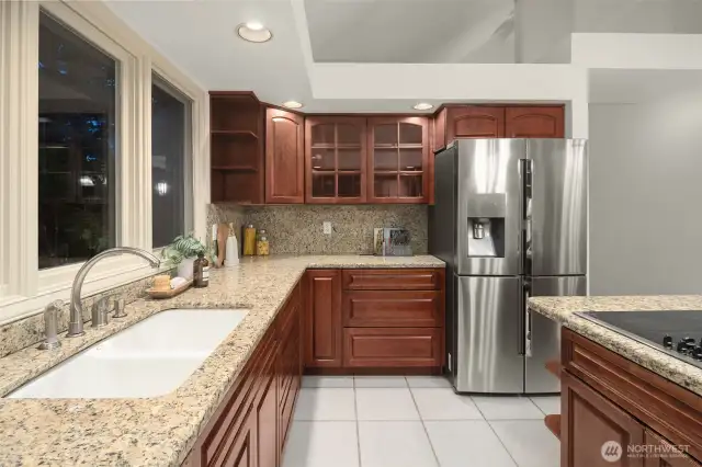 Kitchen features stainless steel appliances  recessed lighting, and a eat-in island with ample storage.