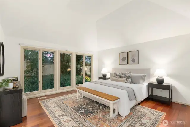 Large primary bedroom with vaulted ceilings.