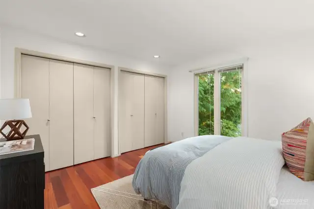 Secondary bedroom features new windows, closet and hardwoods