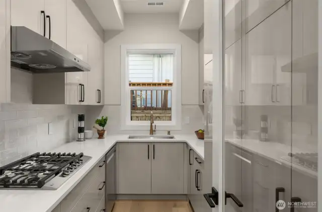 Prep kitchen with gas cooktop, second kitchen sink and a second dishwasher