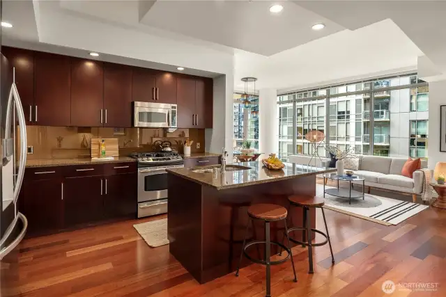 Step inside to open concept living. Looking across the kitchen to the living room.
