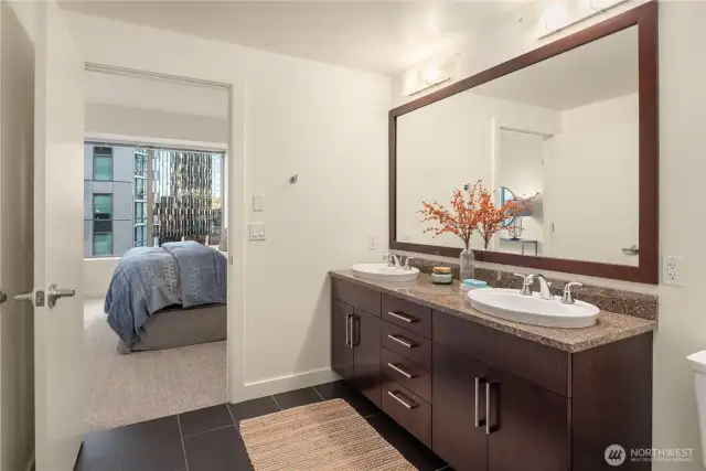 This spacious bath features double sinks and walk-in shower.