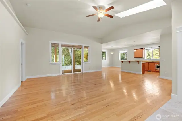 View of living room from the entryway looking toward the kitchen, dining and back yard