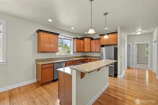 View of the kitchen and looking toward the hall bathroom and two bedrooms
