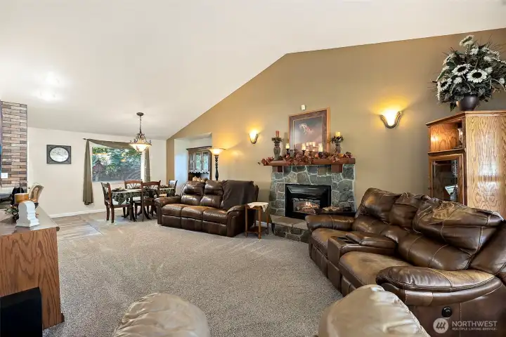 Large living room features vaulted ceilings and a gas fireplace.