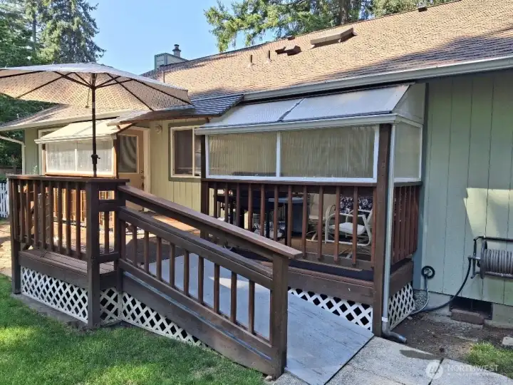 Back deck, with removable windows to partially enclose the space in the colder/wetter months.