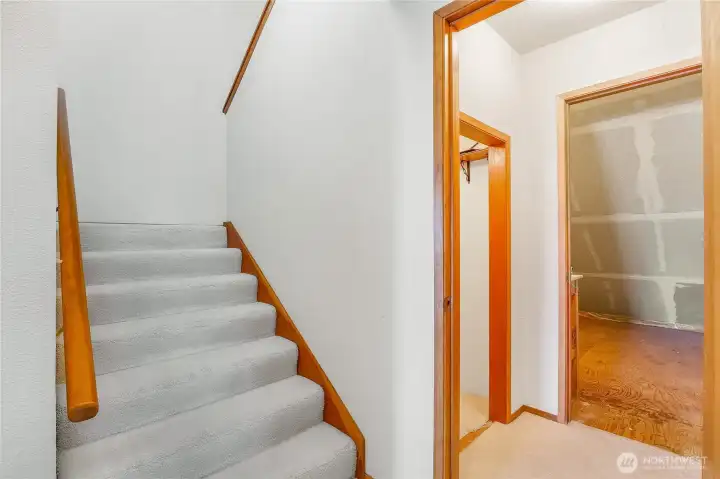 Well-lit staircase leads to your private primary retreat