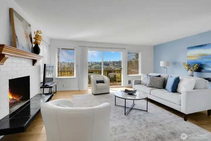 Living Room with Wood Burning Fireplace & Sliding Glass Doors to View Deck