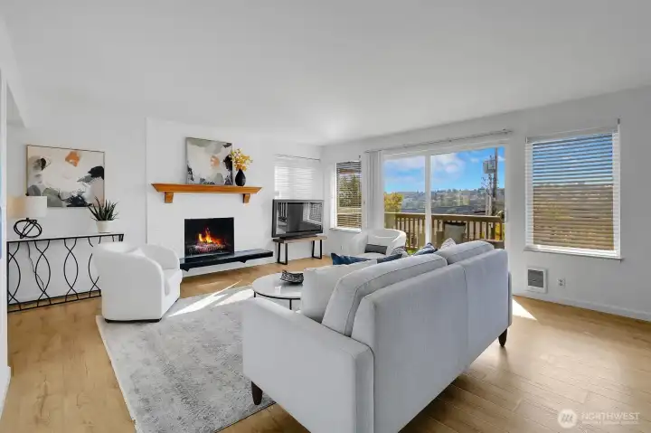 Living Room with Wood Burning Fireplace & Sliding Glass Doors to View Deck