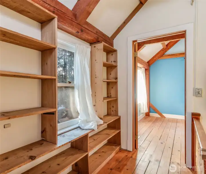 2nd floor with built-in bookshelves in hallway between bedrooms.