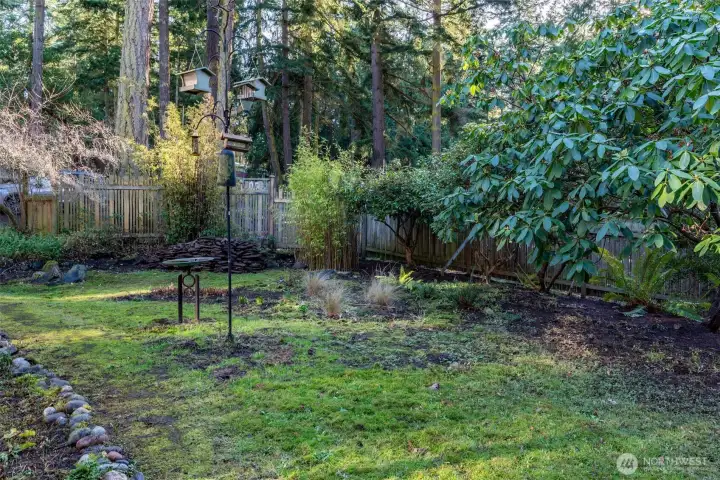 Side yard with fence provides ample privacy from road.