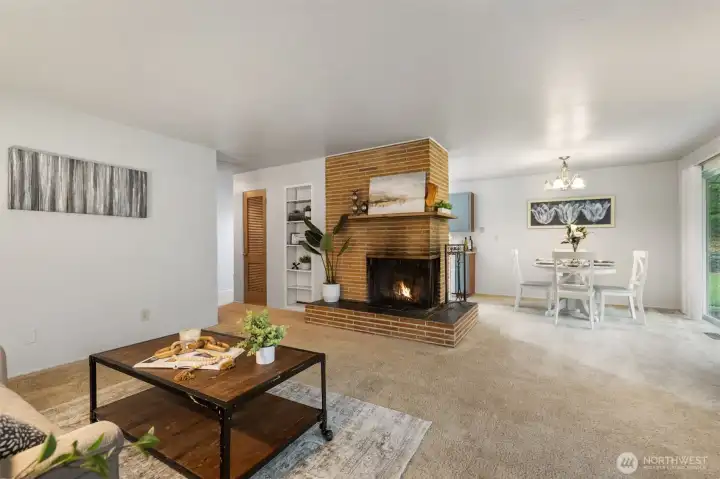 Open living area featuring a fireplace and dining area