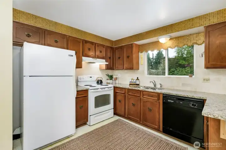 granite counters & tile back splash-view to back yard is territorial