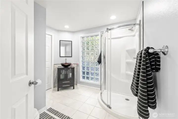 Main floor 3/4 bathroom with beautiful natural light.