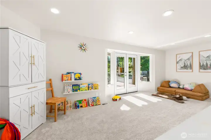 French doors of bonus room open to large deck for patio dining and outdoor living!