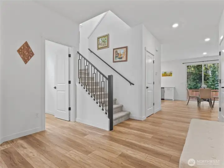 A roomy entry with gorgeous vinyl plank flooring and a fun stair railing greet you when you come home.