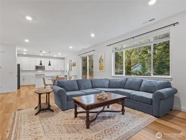 A fuller view of the livings space looking back from the fireplace. Blinds are included for most windows.