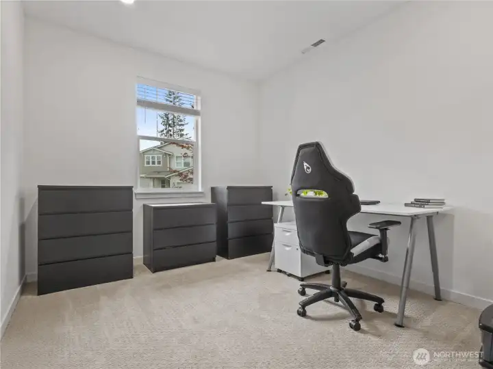 Back toward the front of the home is a versatile office or den space.