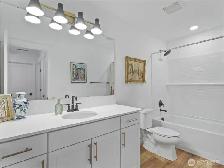 Upstairs bath in hallway with tub/shower and considerable vanity space.