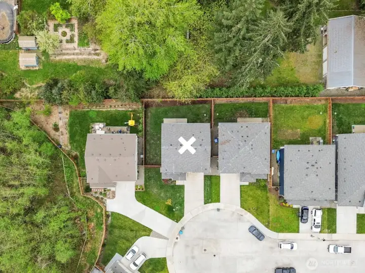 An overhead view showing location of home in the cul-de-sac and nearby trees for added privacy.