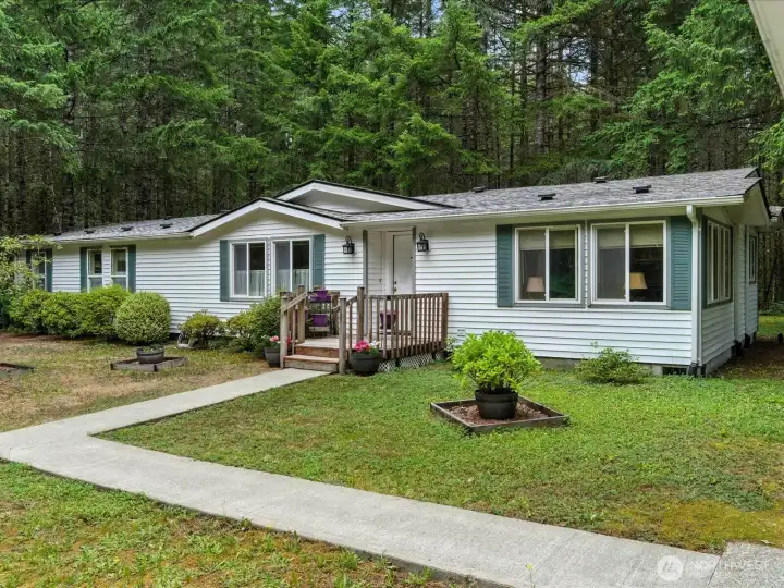 A welcoming garden greets you at the entrance, setting the tone with colorful plantings and a peaceful, inviting feel as you arrive home.