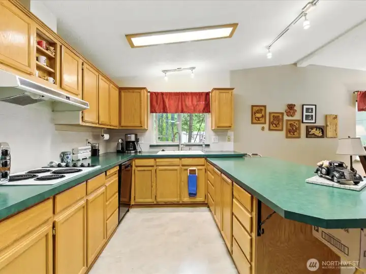 The kitchen offers excellent storage with ample cabinetry and thoughtfully designed space to keep everything organized and within easy reach.