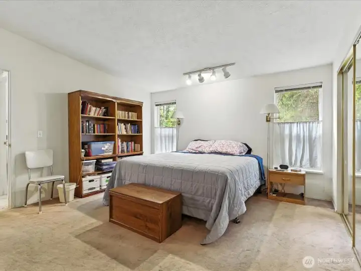 Generous primary suite offering a quiet place to unwind with views of the surrounding property.