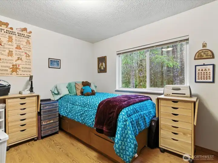 The third bedroom features a window overlooking the backyard, bringing in natural light and offering a peaceful view of the outdoors.