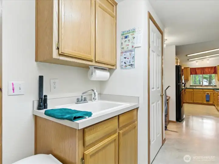 The utility area includes a convenient sink—perfect for rinsing off after outdoor work and keeping dirt and mess from being tracked into the home.