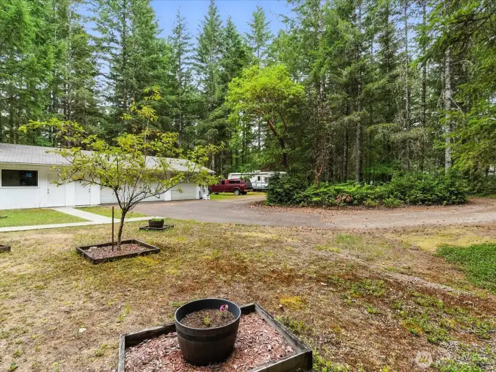The expansive front yard features a circular driveway for easy access and ample parking, along with additional space for RV parking—perfect for accommodating guests, toys, or extra vehicles.